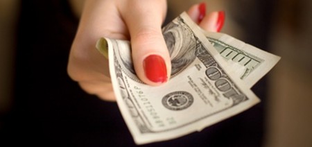 Woman hand giving money. Specially very small DOF.