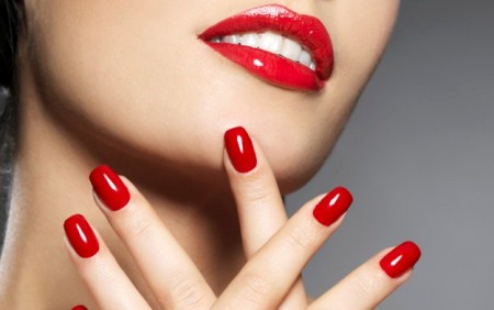 woman with fashion red nails and sensual lips